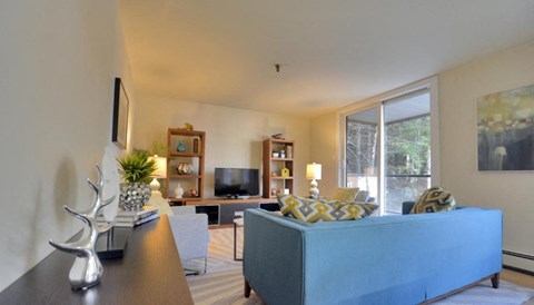 a living room with a blue couch and a tv